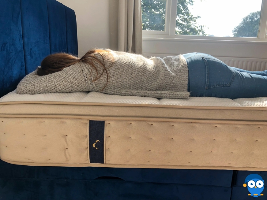 Lady sleeping on the front on a Dreamcloud mattress.